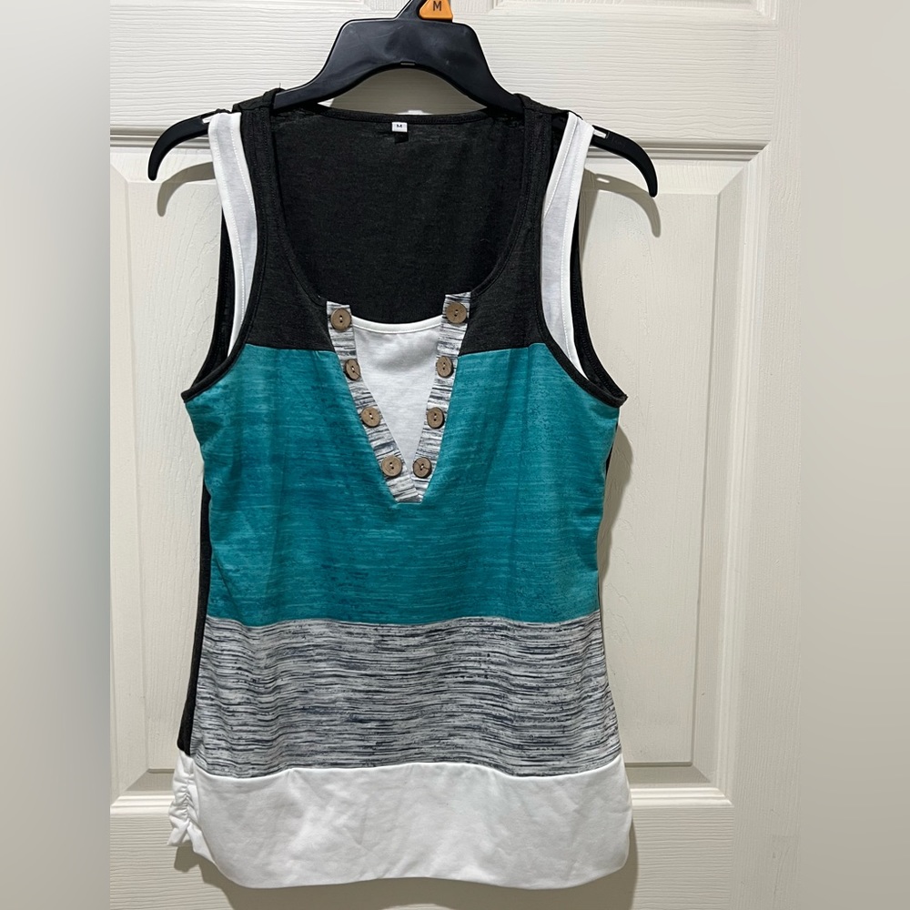 Cute button detail layered look. super cute on. Size medium true to size.